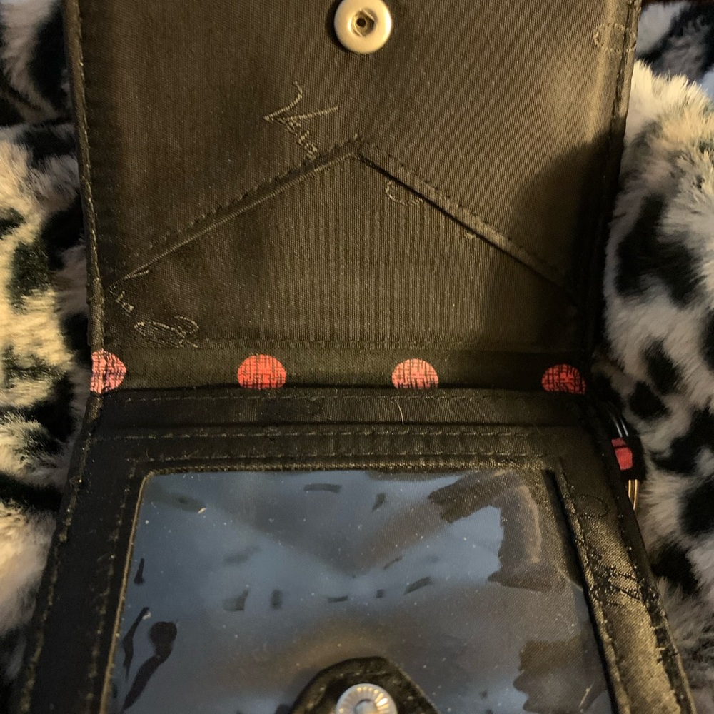 Keychain wallet, holds Two photo I.Ds & card slot, change holder on back.
